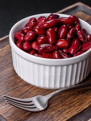 Canned red kidney beans in white bowl on a table